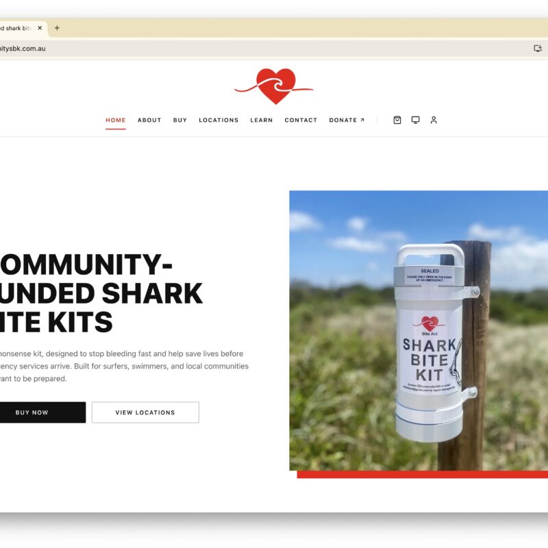 Hero section: bold headline 'COMMUNITY-FUNDED SHARK BITE KITS' with a photo of a Shark Bite Kit mounted on a fence post to the right